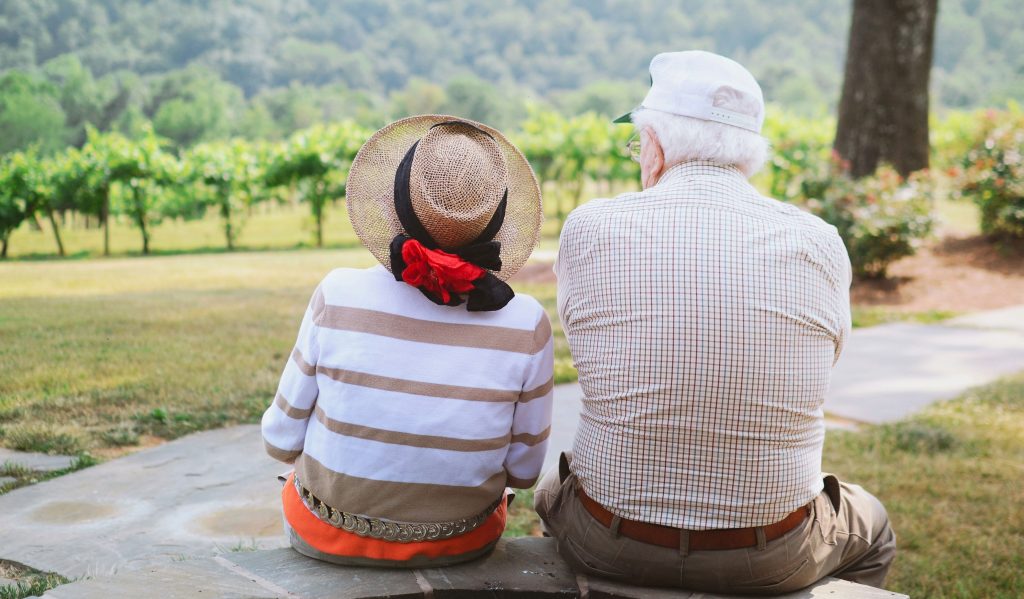 Two older people looking out over a scenic landscape. We offer a variety of investment types to fund your retirement.