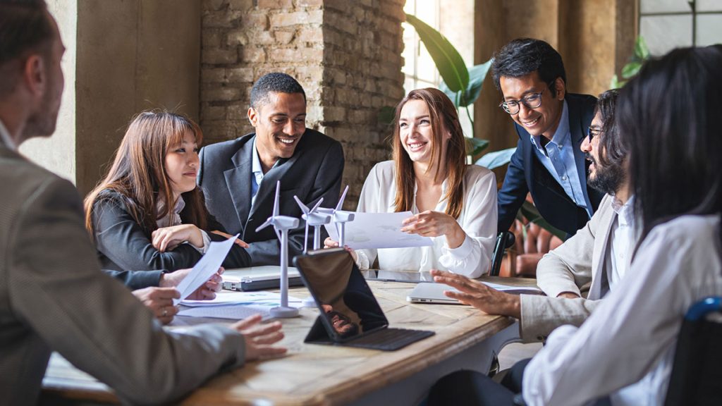 Group benefits: a group of workers sitting around a conference table talking.